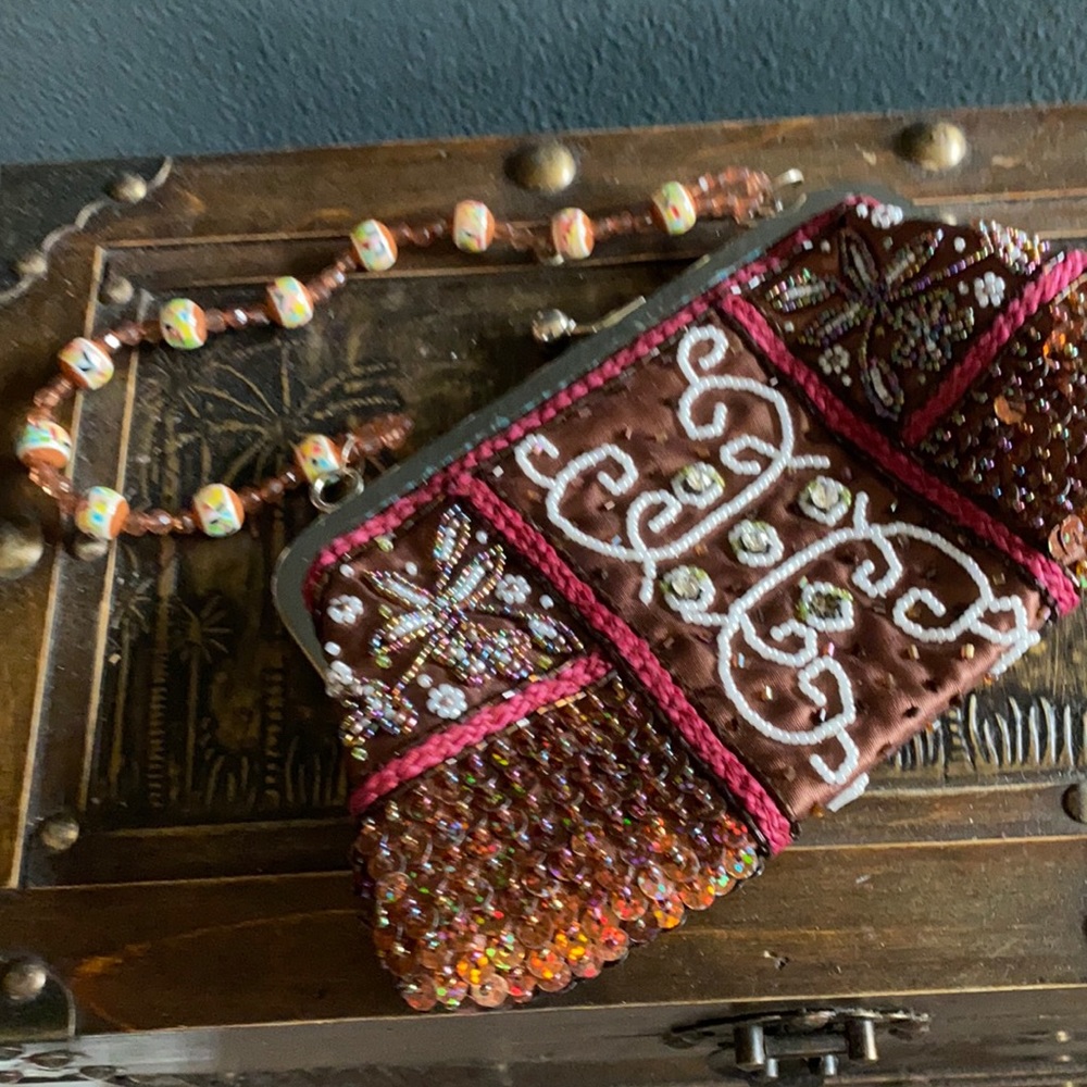 Stunning brown, red, and pink surrounded with jewelry. Gorgeous for evening wear